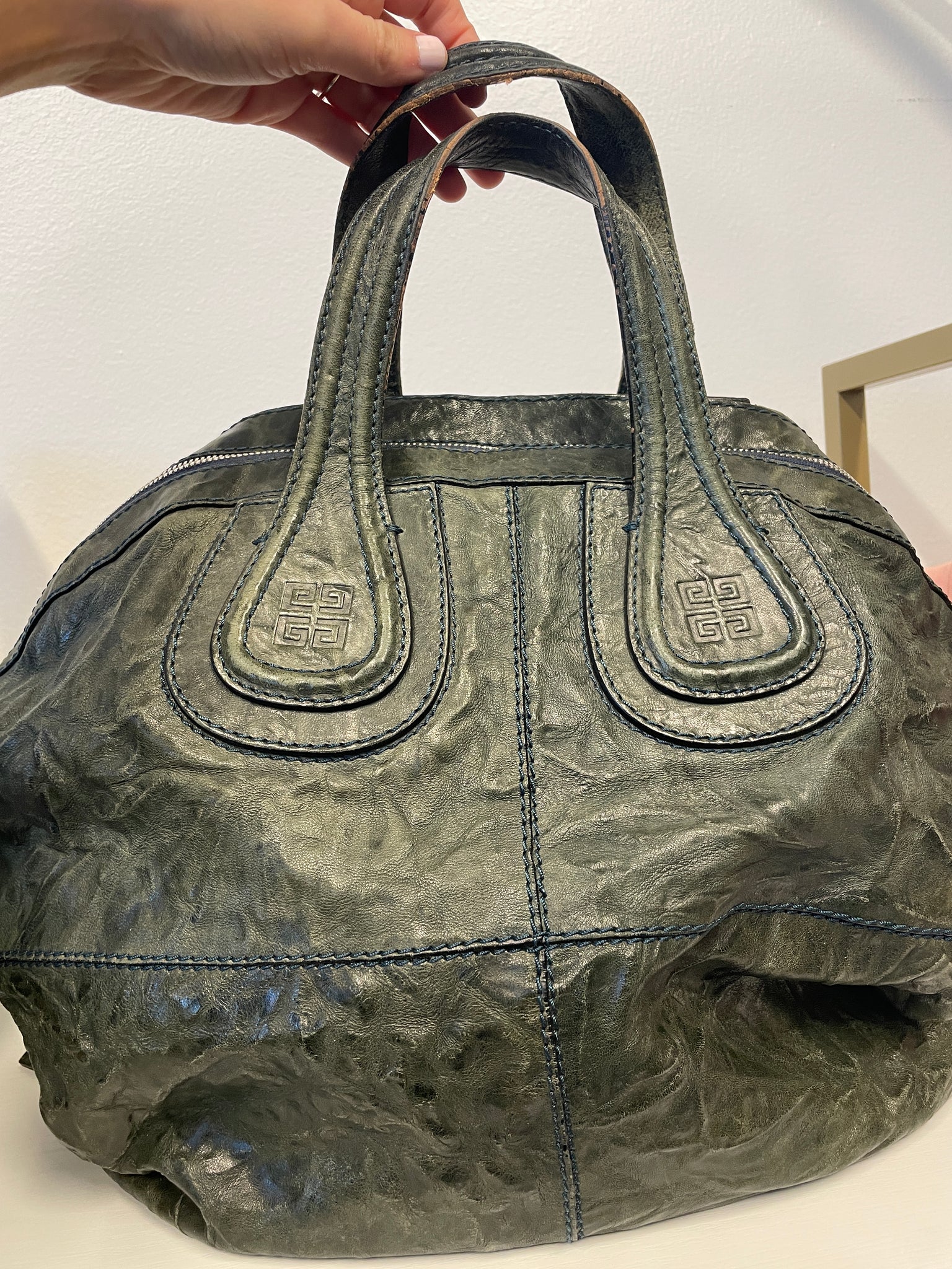 Back view of Givenchy tote with dual handles and shoulder strap.