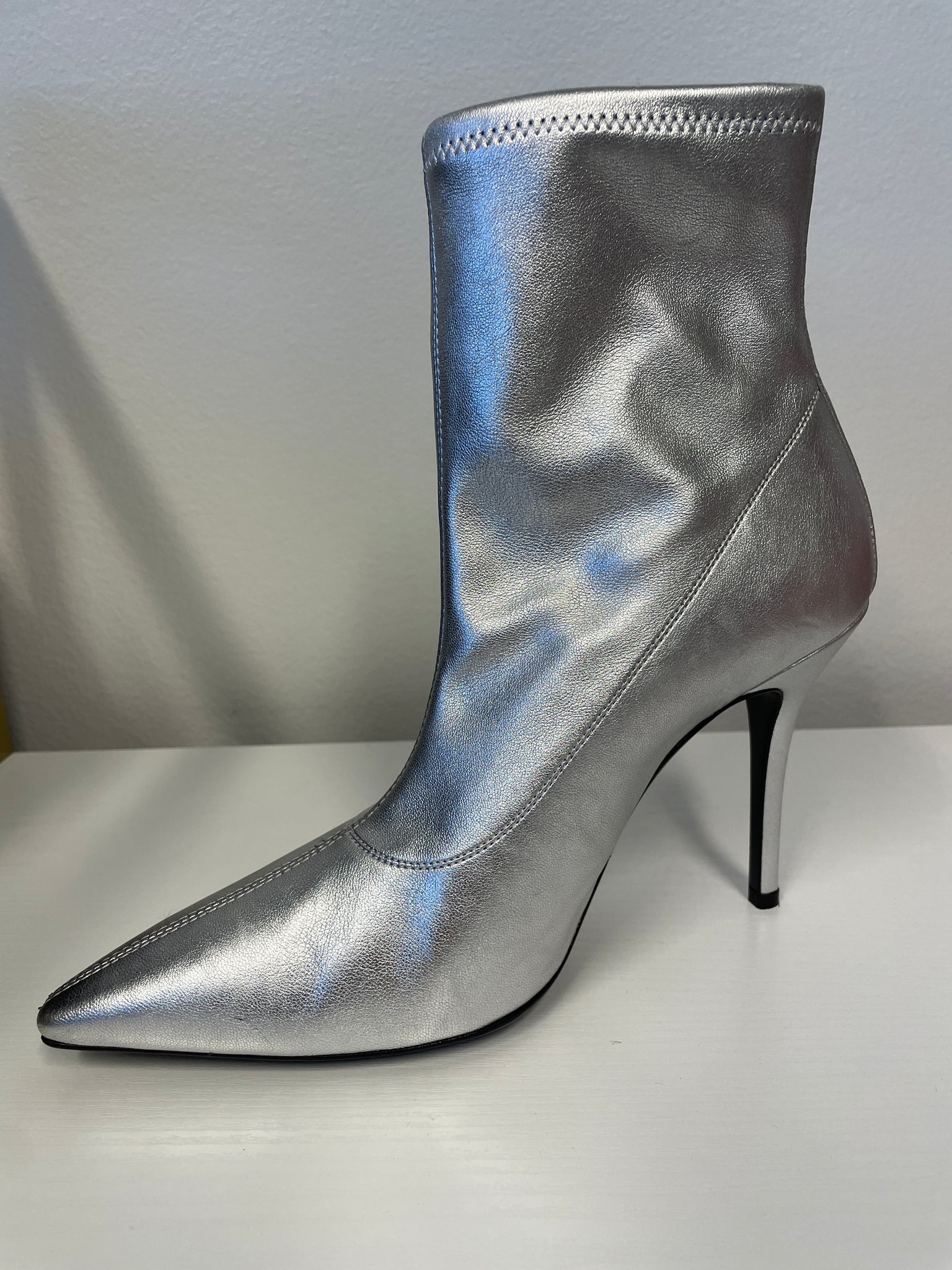 Side view showing pointed toe and stiletto heel.
