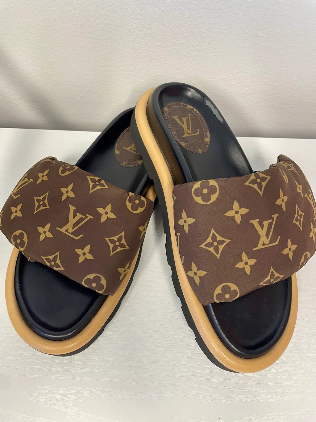 Front angle of Louis Vuitton Pool Pillow Comfort Flat Mules in Monogram nylon.