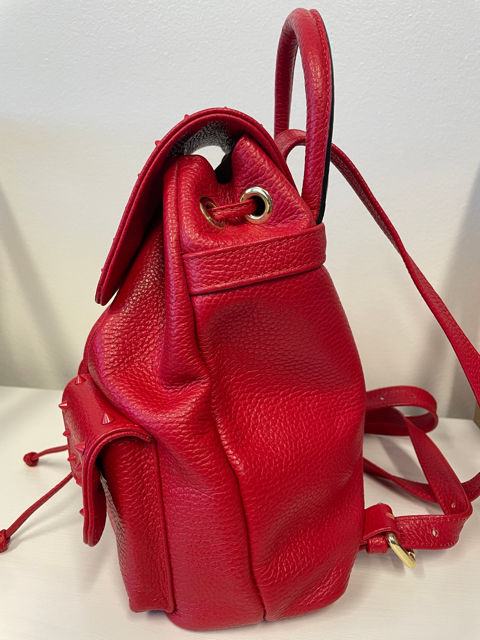 Side profile of Valentino Rockstud backpack with adjustable straps.