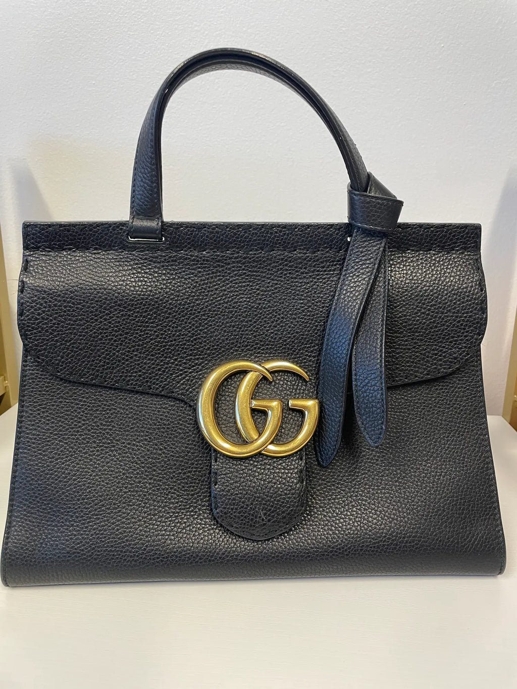 Gucci GG Marmont Animalier Leather Handbag in black with gold GG hardware.