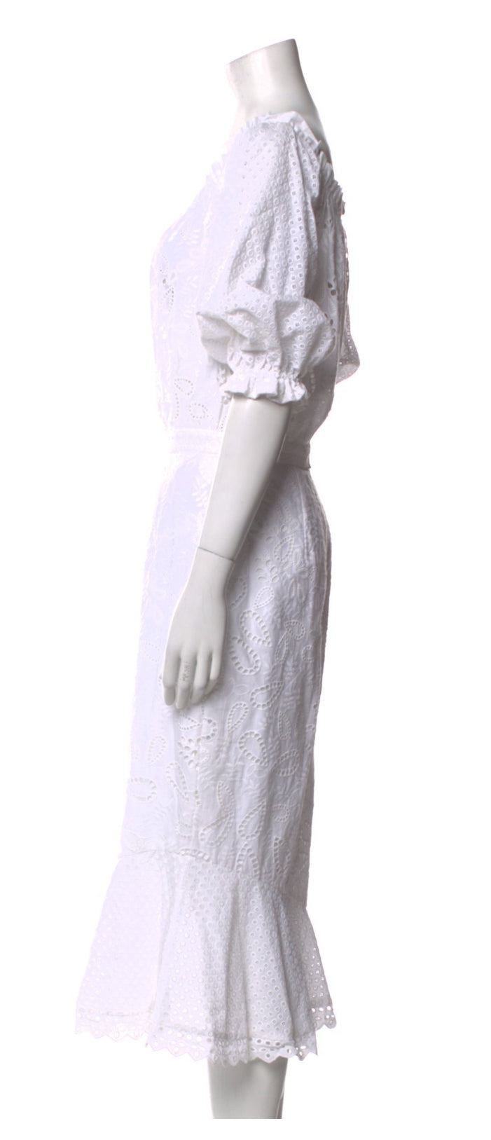 Side profile showing fitted waist and fluted hemline.