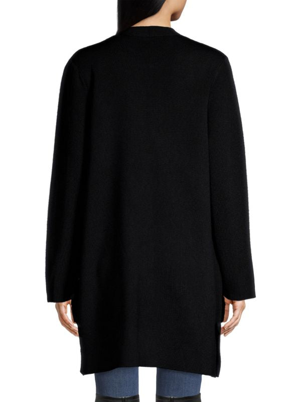 Back view of relaxed-fit black cardigan with faux fur pocket detail.