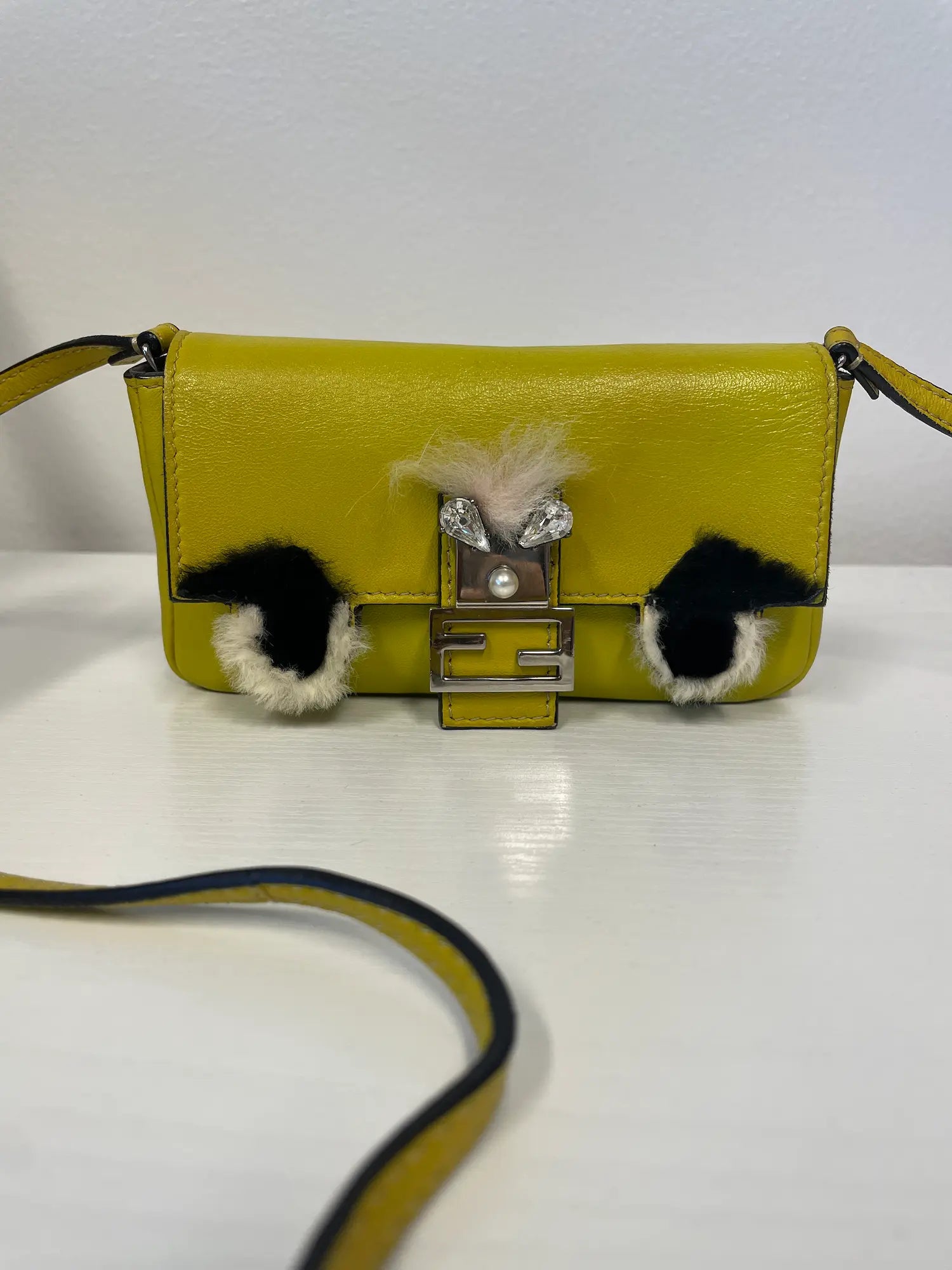 Front view of Fendi Micro Mini Monster Baguette in yellow leather.