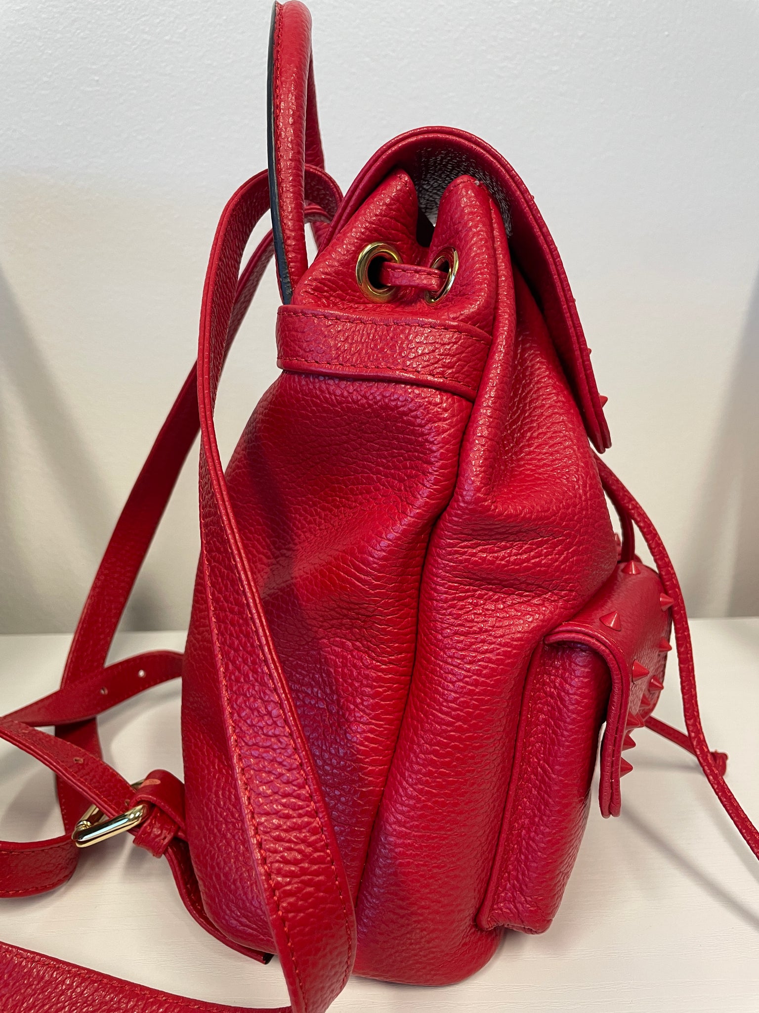 Side profile of Valentino Rockstud backpack with adjustable straps.