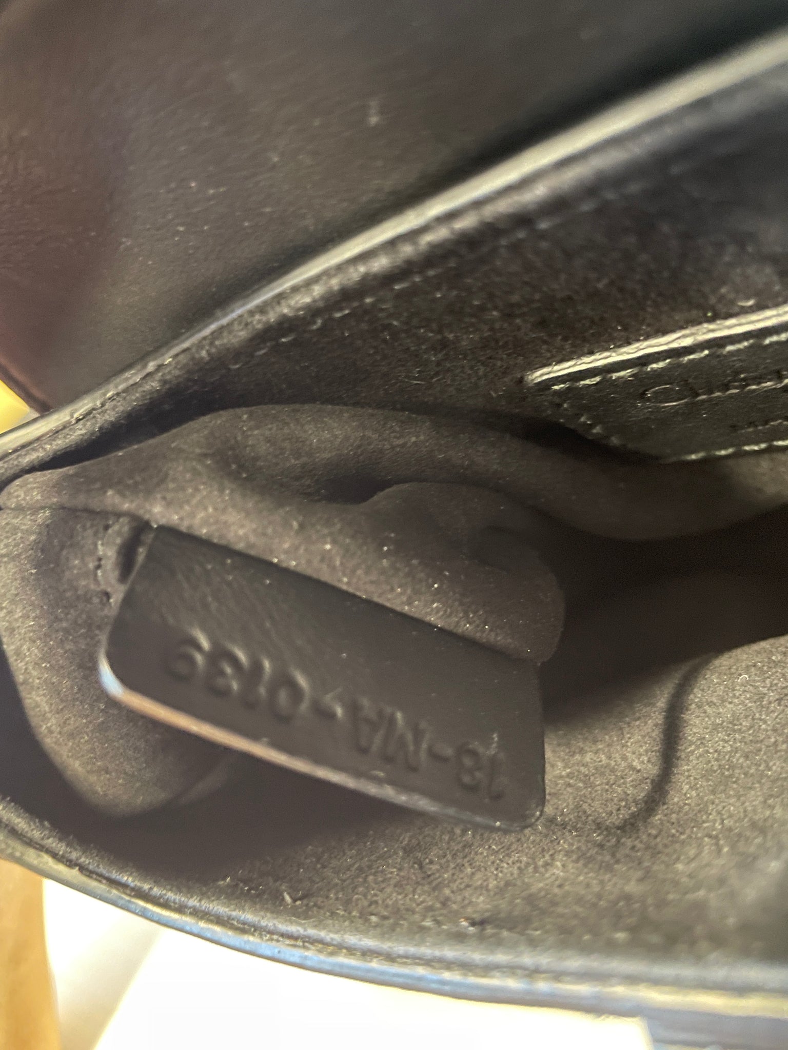 Interior view of Dior Saddle Bag showing lining and logo detail.