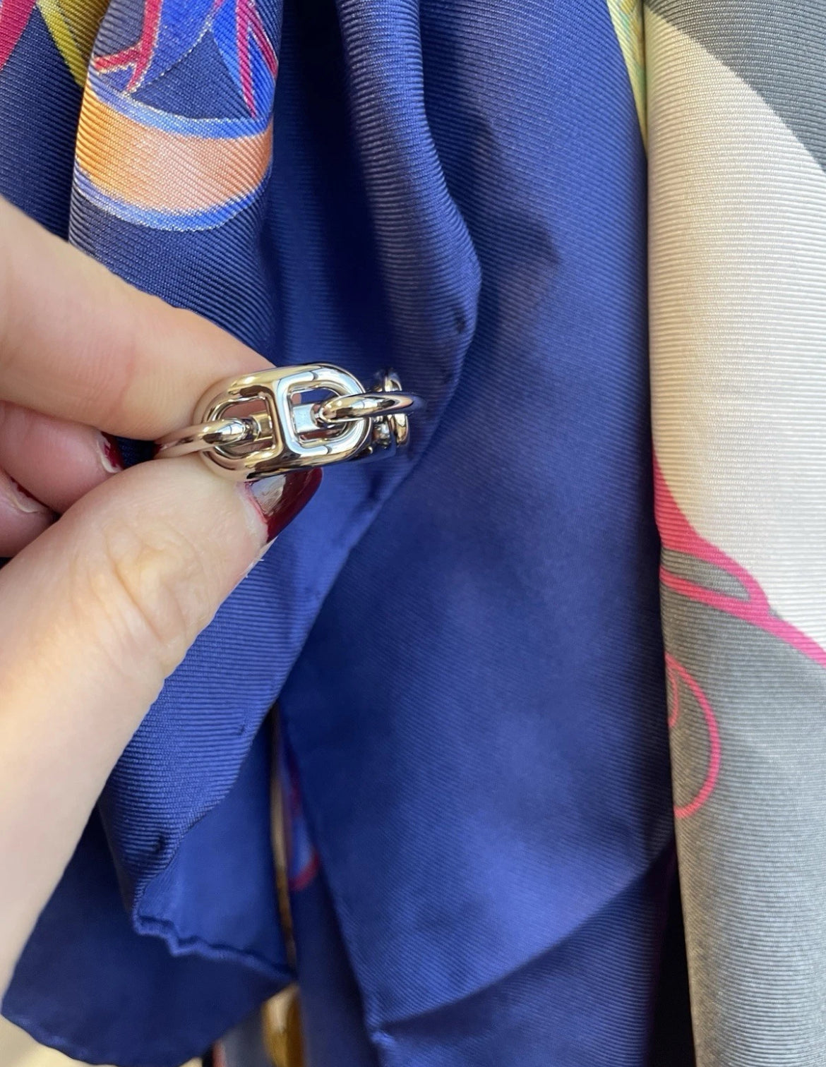 Close-up of HERMES Regate scarf ring showing nautical-inspired link design.