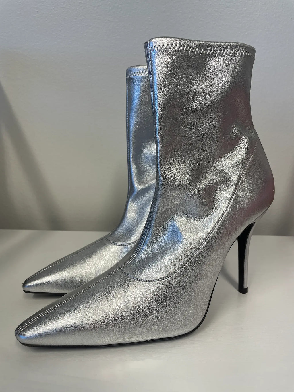 Front angle of Giuseppe Zanotti metallic silver ankle boots.