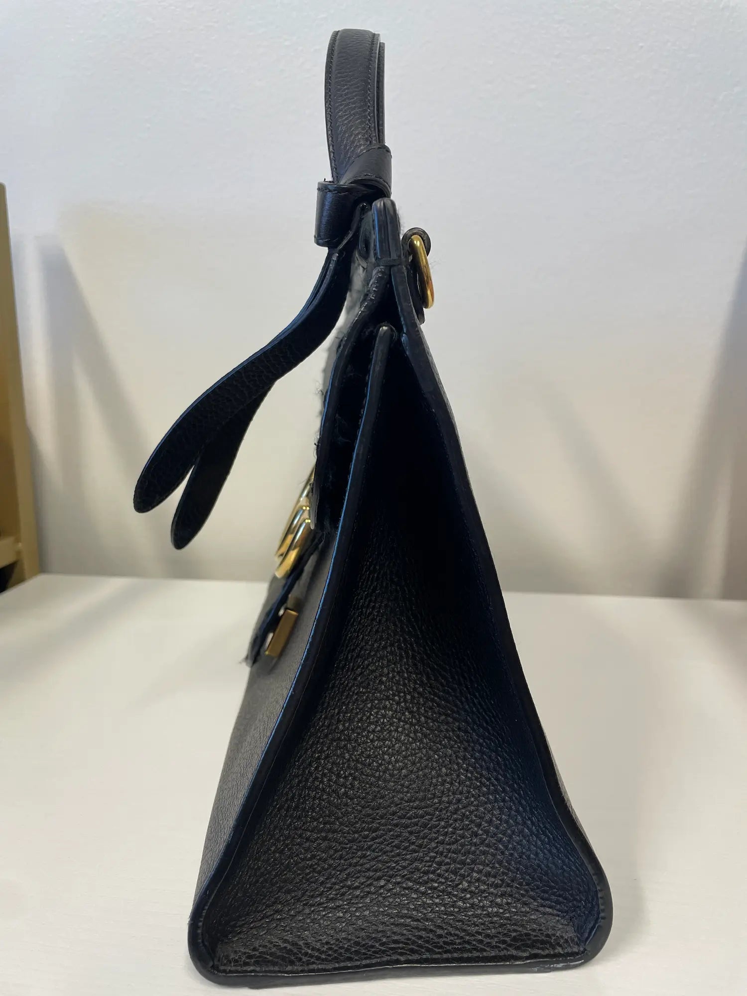 Side view of Gucci Marmont Animalier handbag showing structure and grain texture.