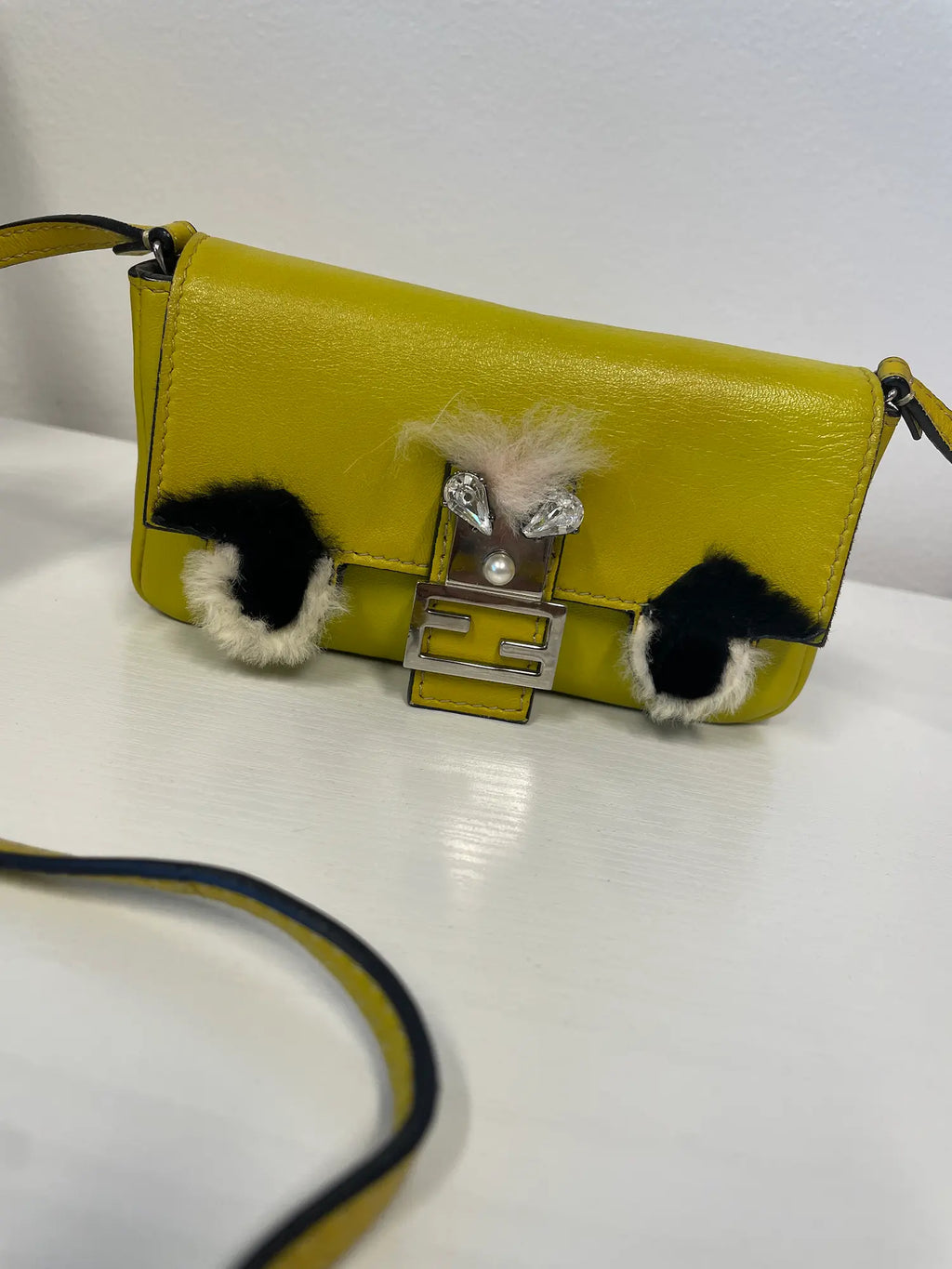 Front view of Fendi Micro Mini Monster Baguette in yellow leather.