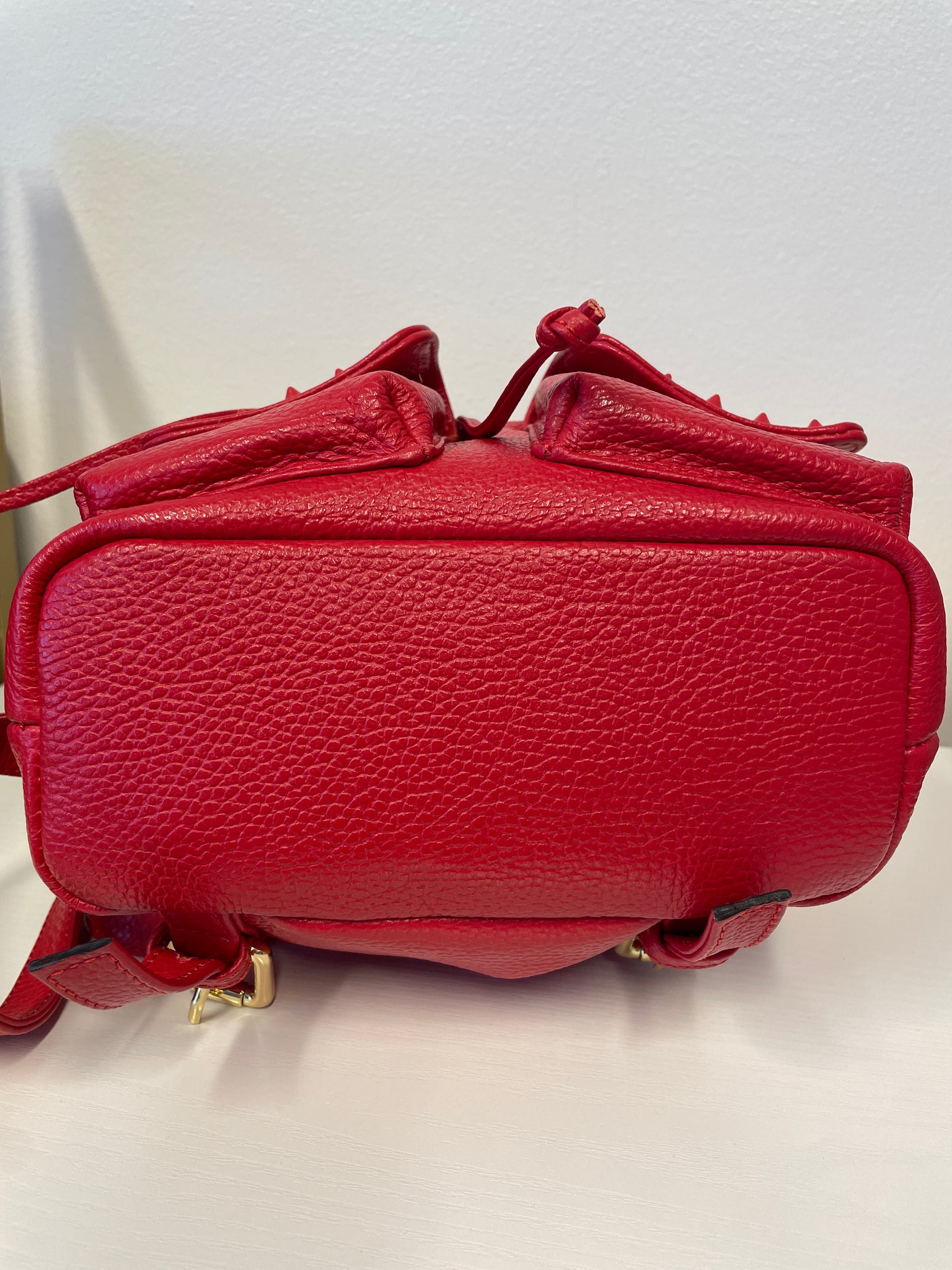 Valentino Rockstud Leather Backpack in red with gold-tone hardware.