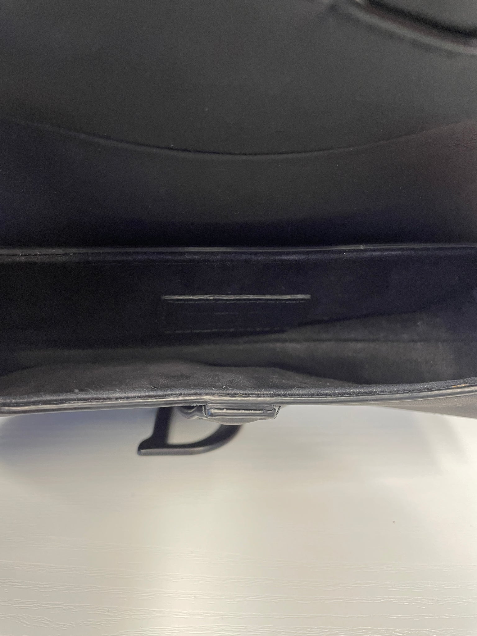 Interior view of Dior Saddle Bag showing lining and logo detail.
