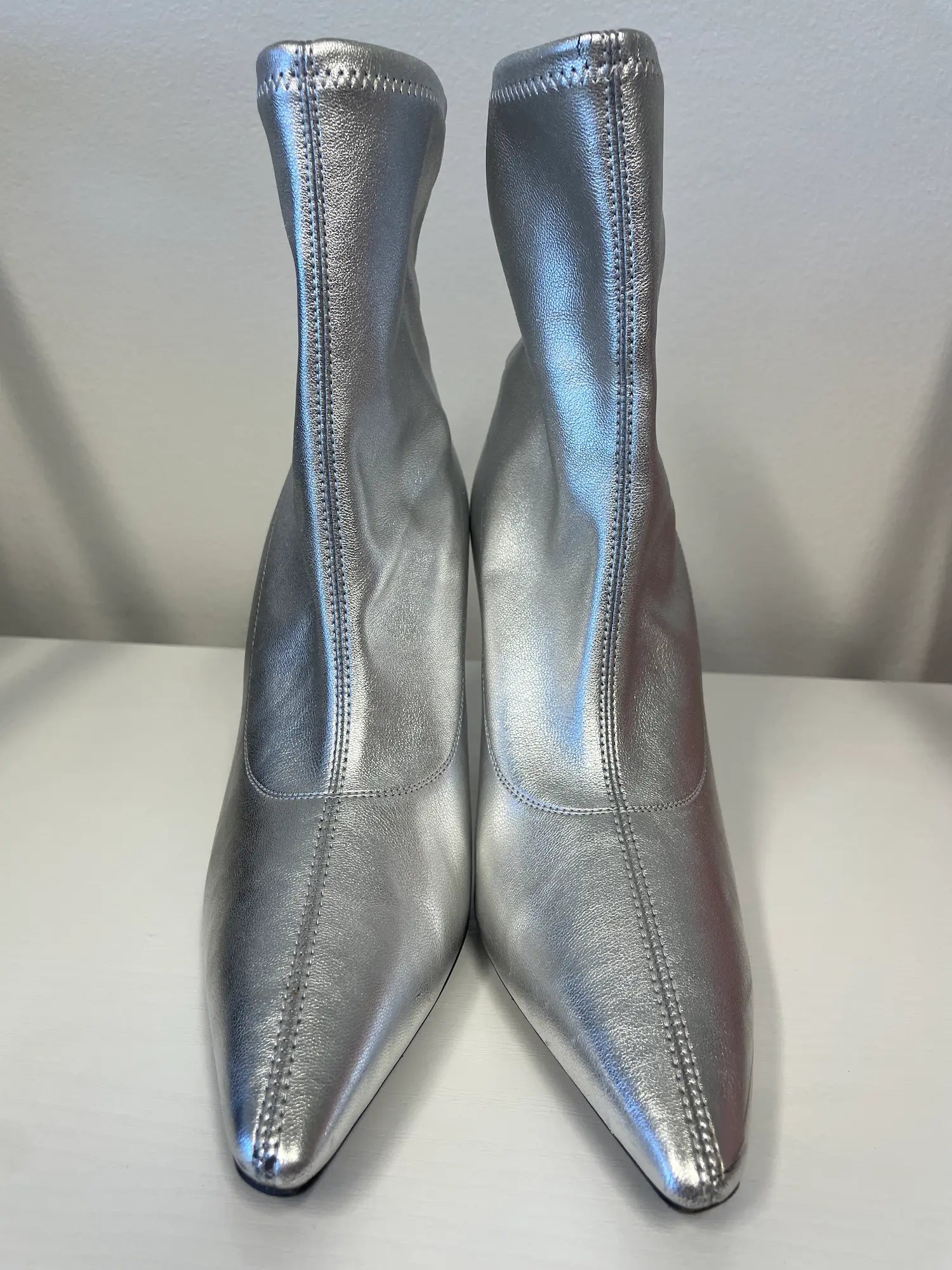 Front angle of Giuseppe Zanotti metallic silver ankle boots.