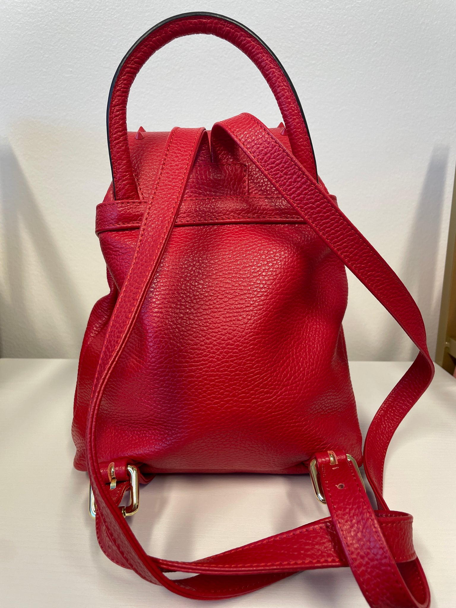 Valentino Rockstud Leather Backpack in red with gold-tone hardware.