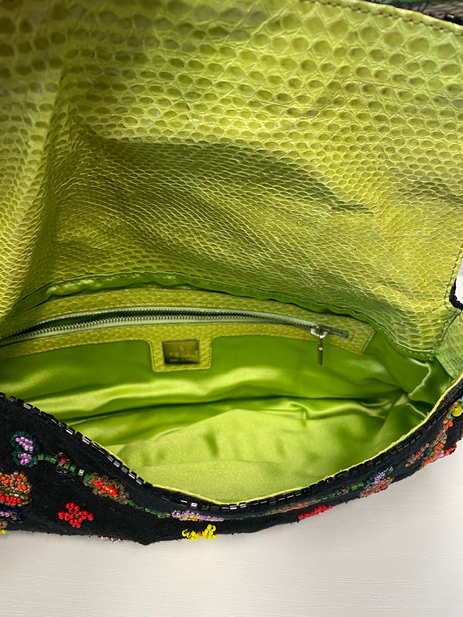 Interior view of Fendi baguette with gold logo plaque and lining.