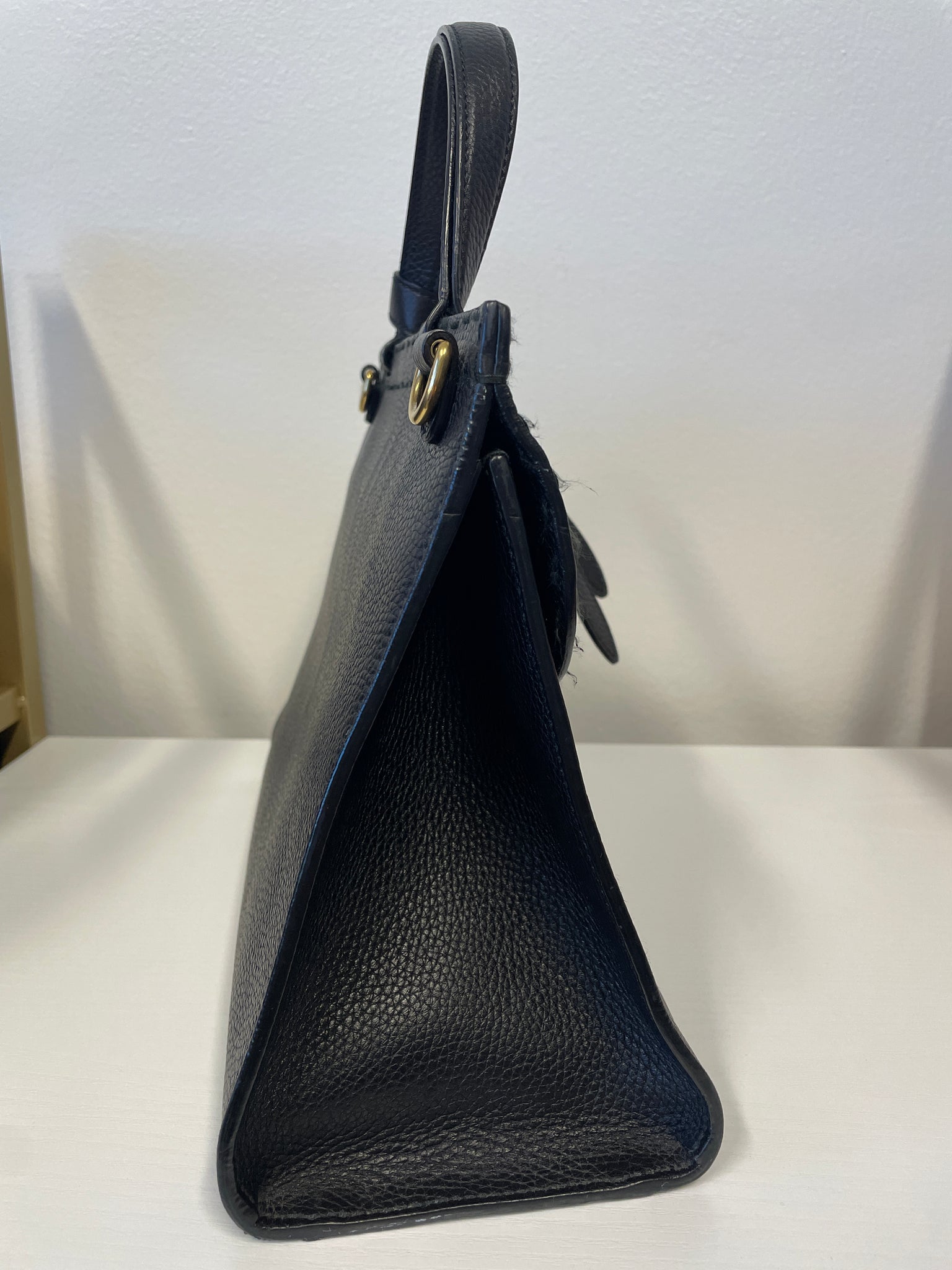 Side view of Gucci Marmont Animalier handbag showing structure and grain texture.