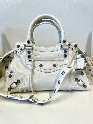Close-up of Balenciaga Neo Cagole handbag aged-silver hardware and zipper details