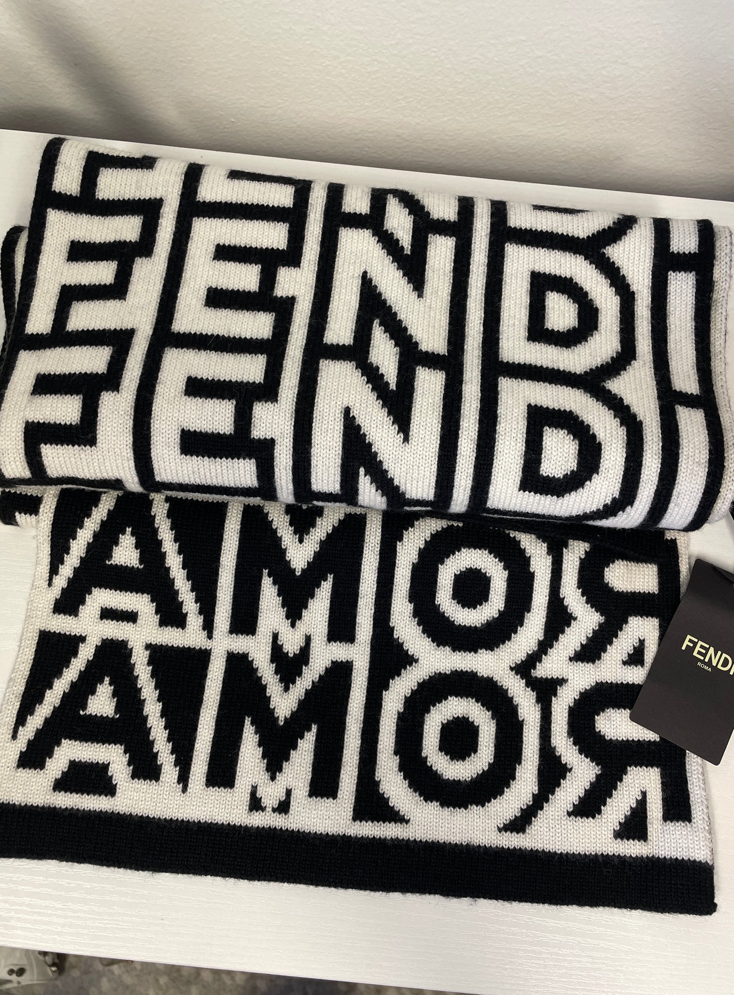 Close-up of black and white Fendi Roma lettering detail.