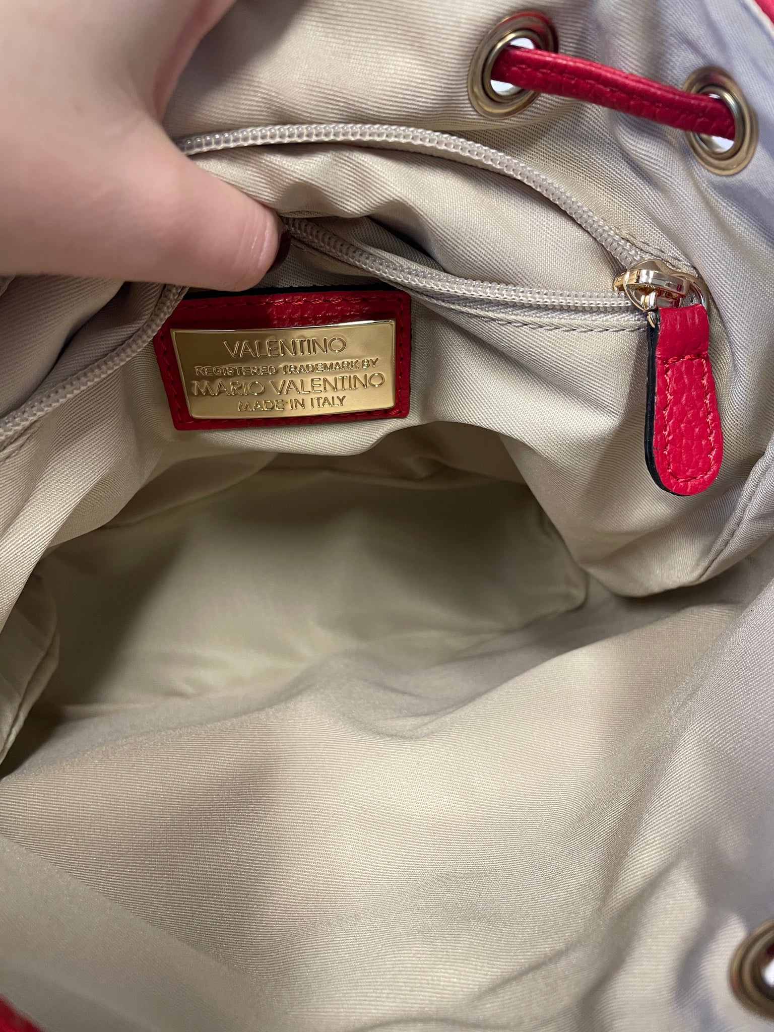 Interior of Valentino red leather backpack with spacious compartment.